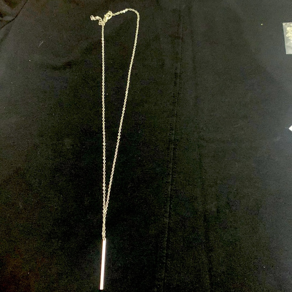Silver necklace with strait bar pendant.